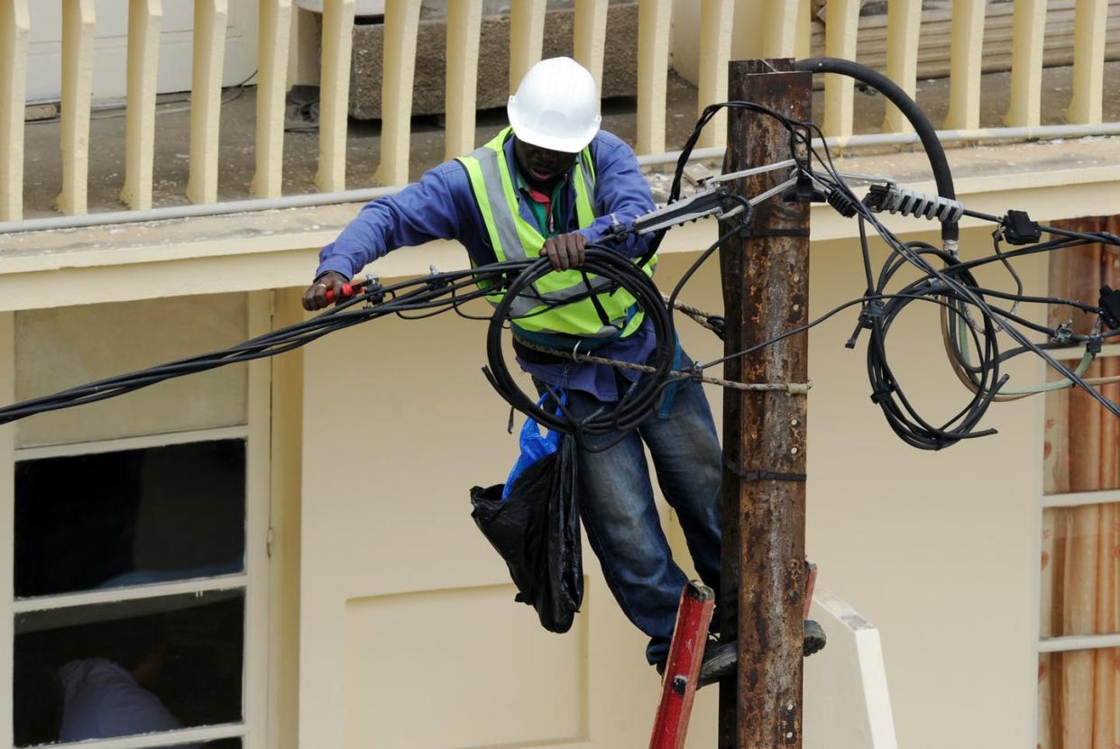 <span class="caption">Less than half the population of sub-Saharan Africa had access to electricity in 2019. </span> <span class="attribution"><a class="link " href="https://www.gettyimages.com/detail/news-photo/worker-fixes-electrical-cables-in-the-plateau-business-area-news-photo/151763247" rel="nofollow noopener" target="_blank" data-ylk="slk:Sia Kambou/AFP/GettyImages;elm:context_link;itc:0;sec:content-canvas">Sia Kambou/AFP/GettyImages</a></span>