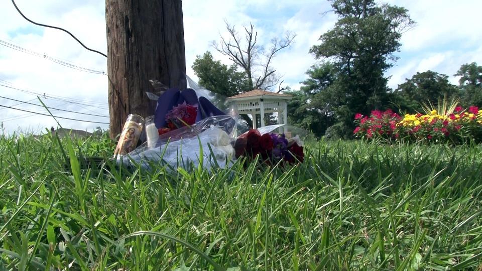 Flowers mark the scene of a fatal car crash in Long Branch
