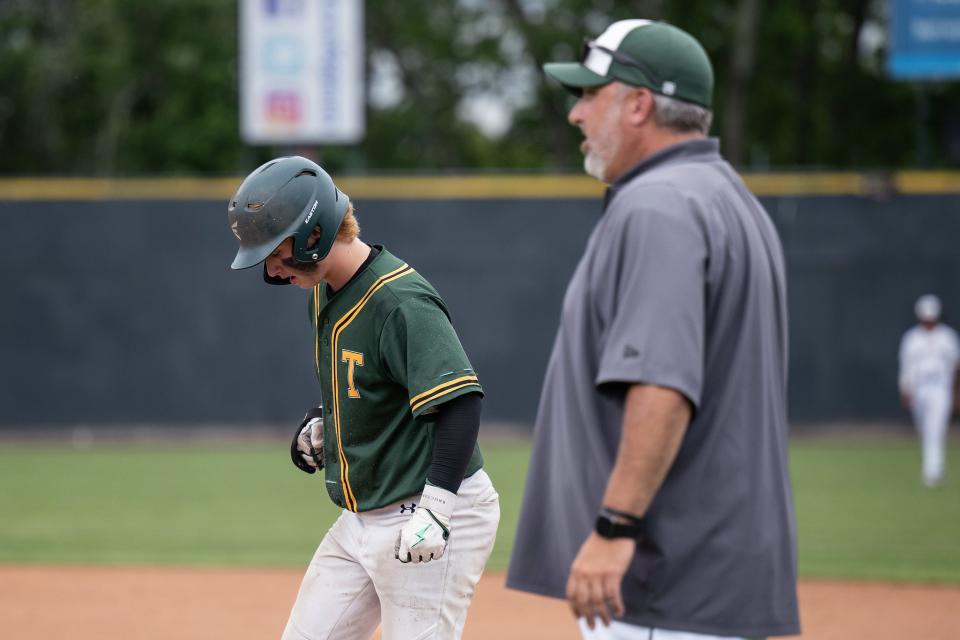 Tantasqua's Petey Casine stands on first while father Peter looks on.