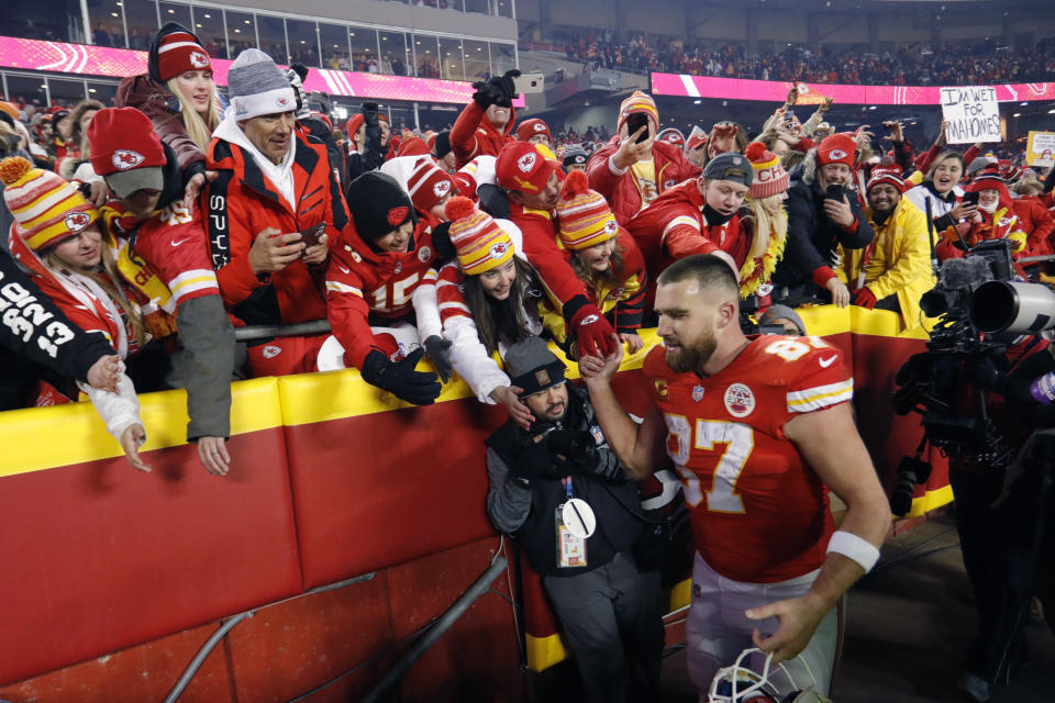 FILE - Kansas City Chiefs tight end Travis Kelce (87) celebrates with fans as he walks off the field after an NFL divisional round playoff football game against the Buffalo Bills, Sunday, Jan. 23, 2022, in Kansas City, Mo. Eager as the National Football League has been to cater to the recent public fixation with Taylor Swift and Travis Kelce, it’s certainly not taking any credit for creating the "situationship" between the pop superstar and the Kansas City Chiefs tight end. (AP Photo/Colin E. Braley, File)