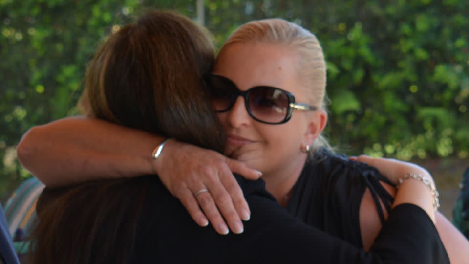 Sally Leydon hugs a supporter outside court on Thursday, February 29, the day the coroner handed down her findings in her mother's inquest. - Angus Watson/CNN