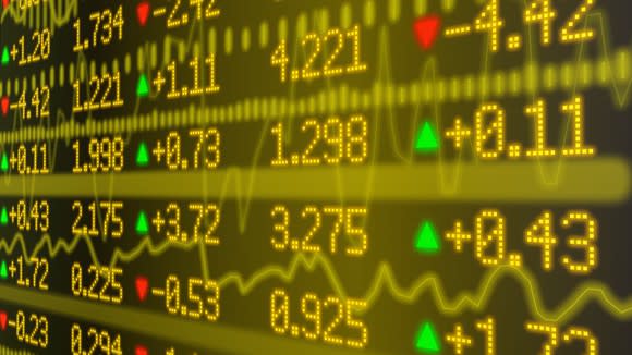 Stock market prices in yellow with red and green arrows indicating direction on an LED display