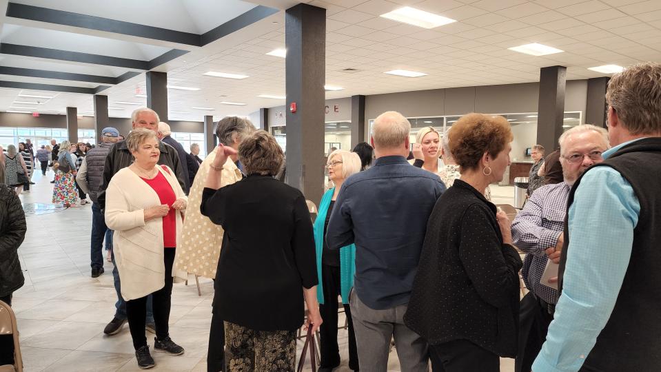 Crowd gather to share words with Judge Ernie Houdashell's family Tuesday at the ceremony naming the Randall County annex after him.