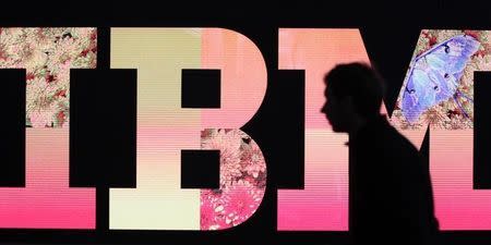 A man passes by an illuminated IBM logo at the CeBIT computer fair in Hanover February 27, 2011. REUTERS/Tobias Schwarz