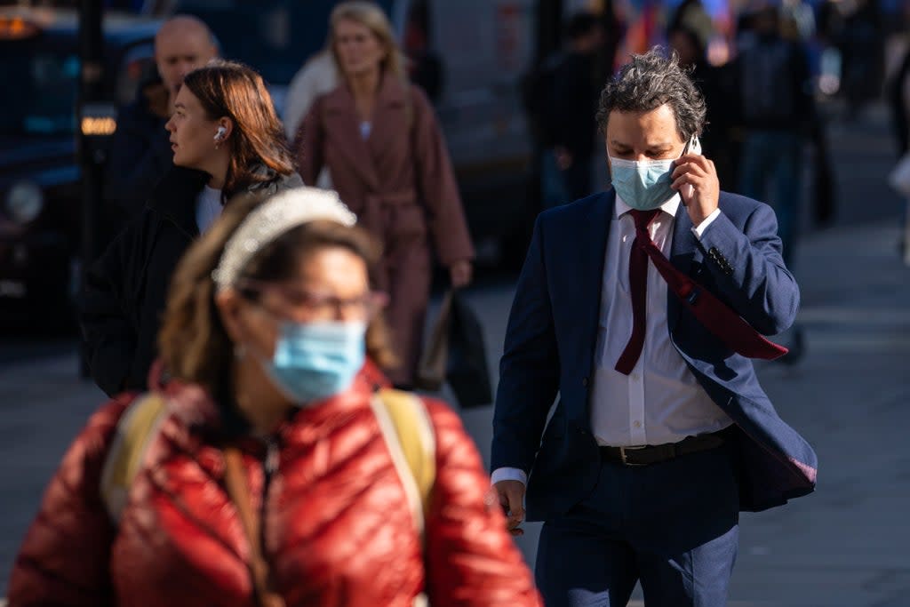 People wearing face masks on Oxford Street in central London  (PA Wire)