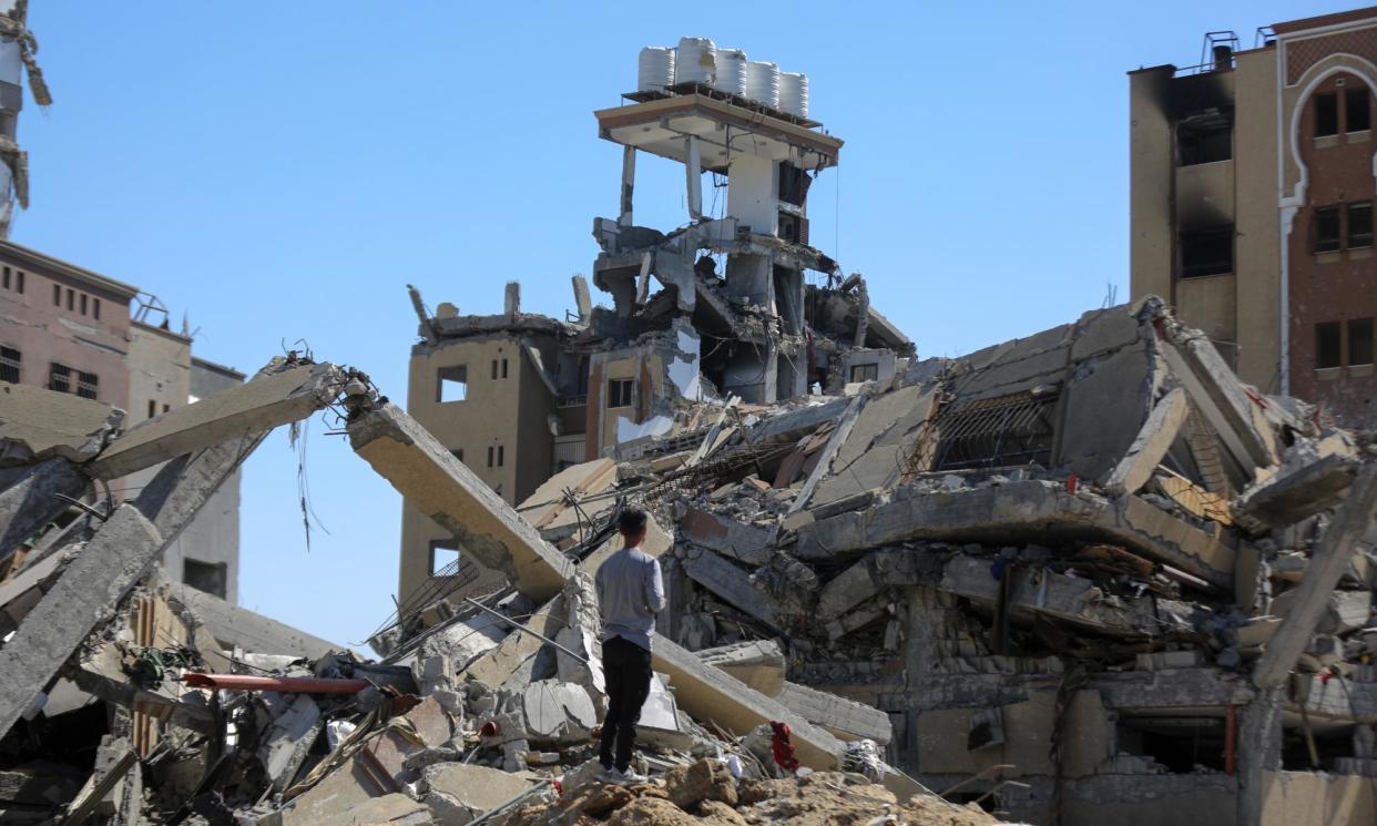 <span>People collect usable items from the rubble of damaged buildings in al-Zahra district of Gaza City.</span><span>Photograph: Anadolu/Getty Images</span>