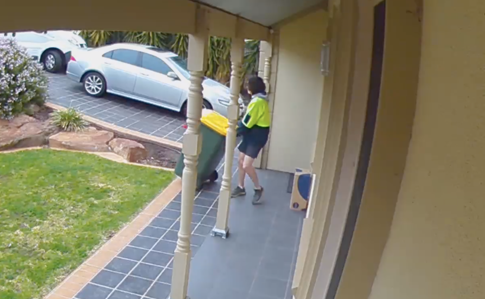 Adelaide Australia Post worker moves bin to hid parcel.