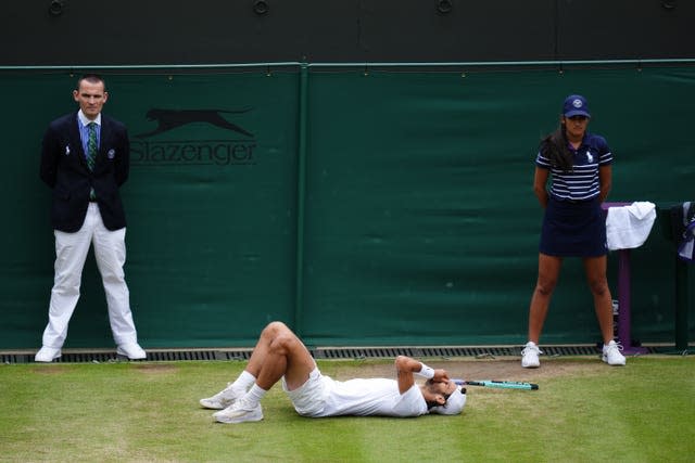 Lorenzo Musetti lies on the floor in celebration