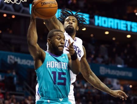 Nov 18, 2017; Charlotte, NC, USA; Charlotte Hornets guard Kemba Walker (15) passes under the basket covered by LA Clippers center DeAndre Jordan (6) during the second half at Spectrum Center. Mandatory Credit: Jim Dedmon-USA TODAY Sports