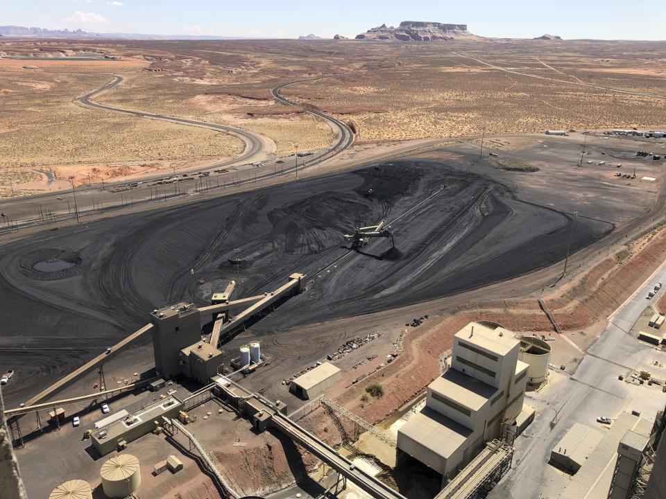 This Aug. 20, 2019, image shows the coal stockpile at the Navajo Generating Station near Page, Ariz. Before the end of the year, the power plant near the Arizona-Utah border will close and others in the region are on track to shut down or reduce their output in the next few years. (AP Photo/Susan Montoya Bryan)