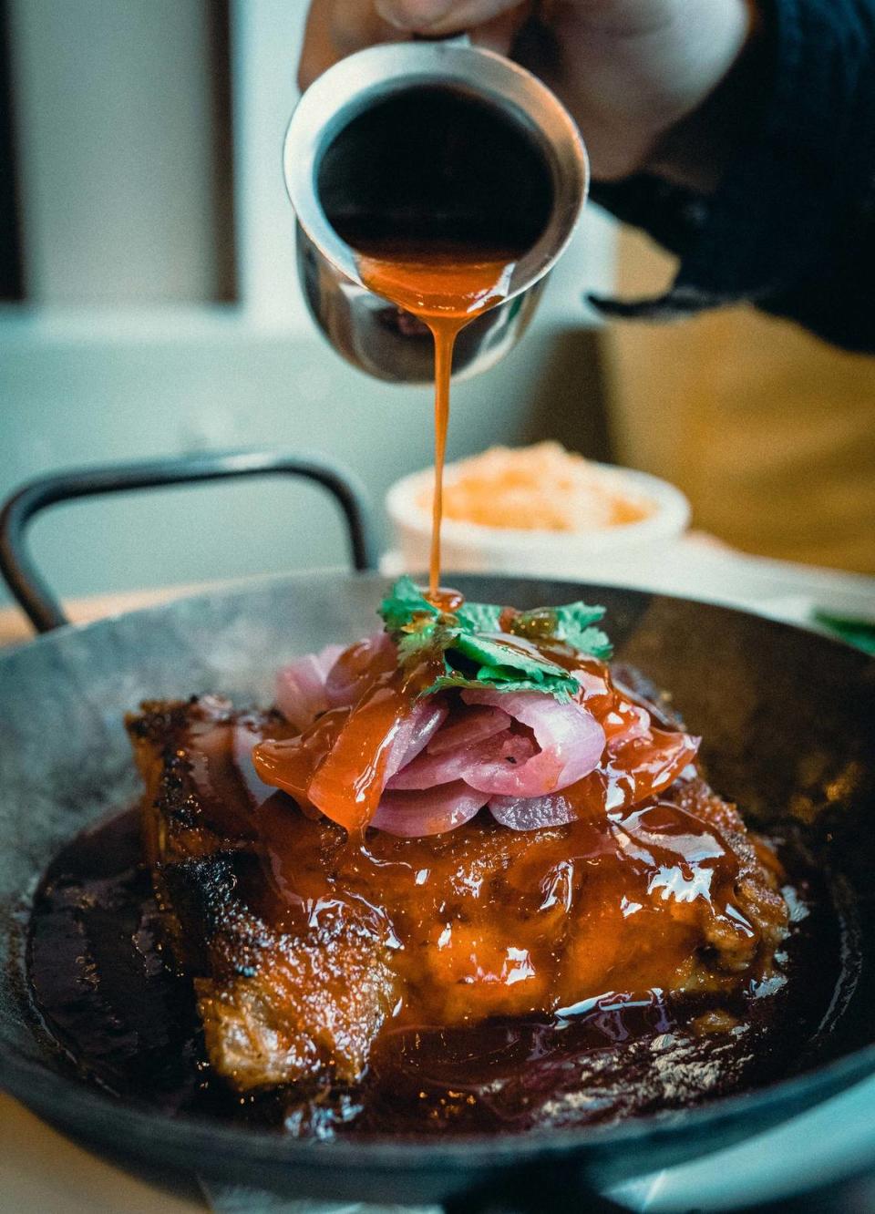 The Cast Iron Pork is slow-cooked pork shoulder in duck fat with a sriracha honey glaze.