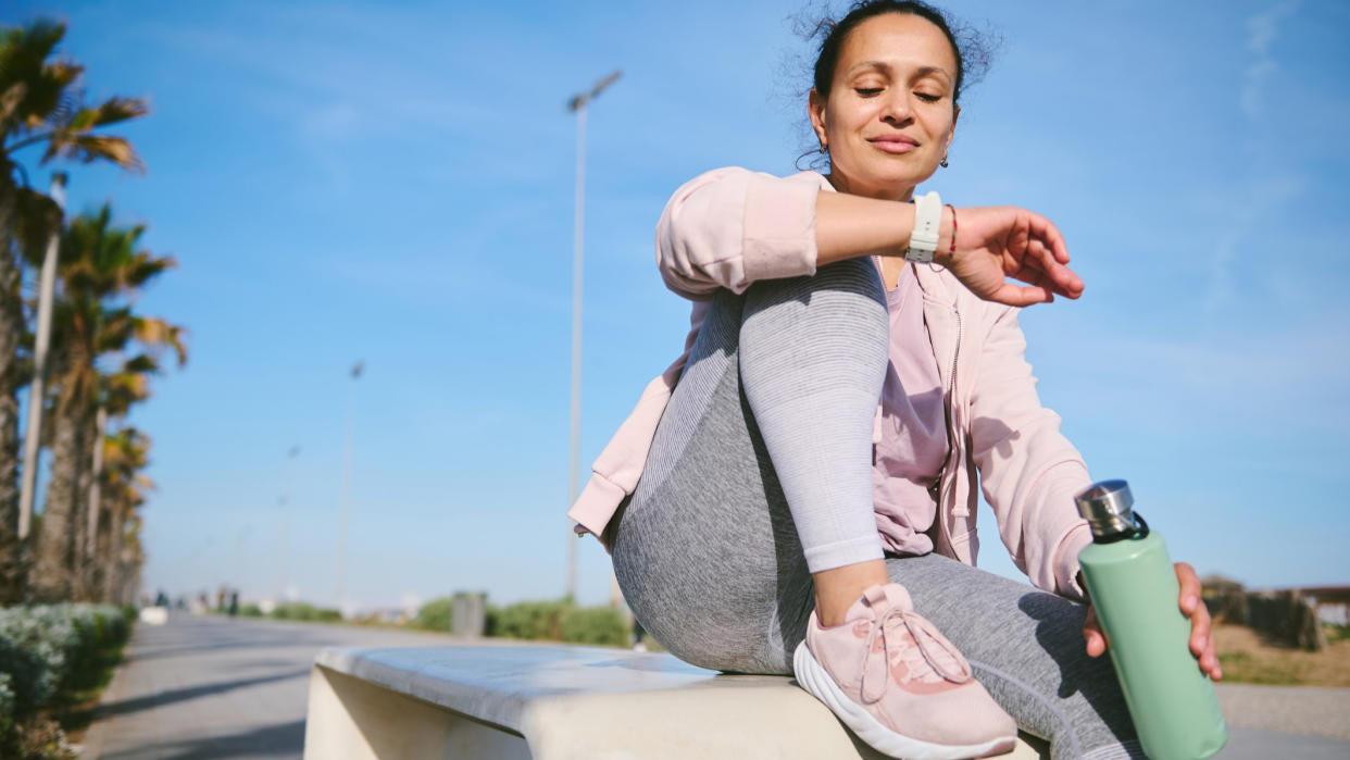  Woman checking sports watch during a workout. 