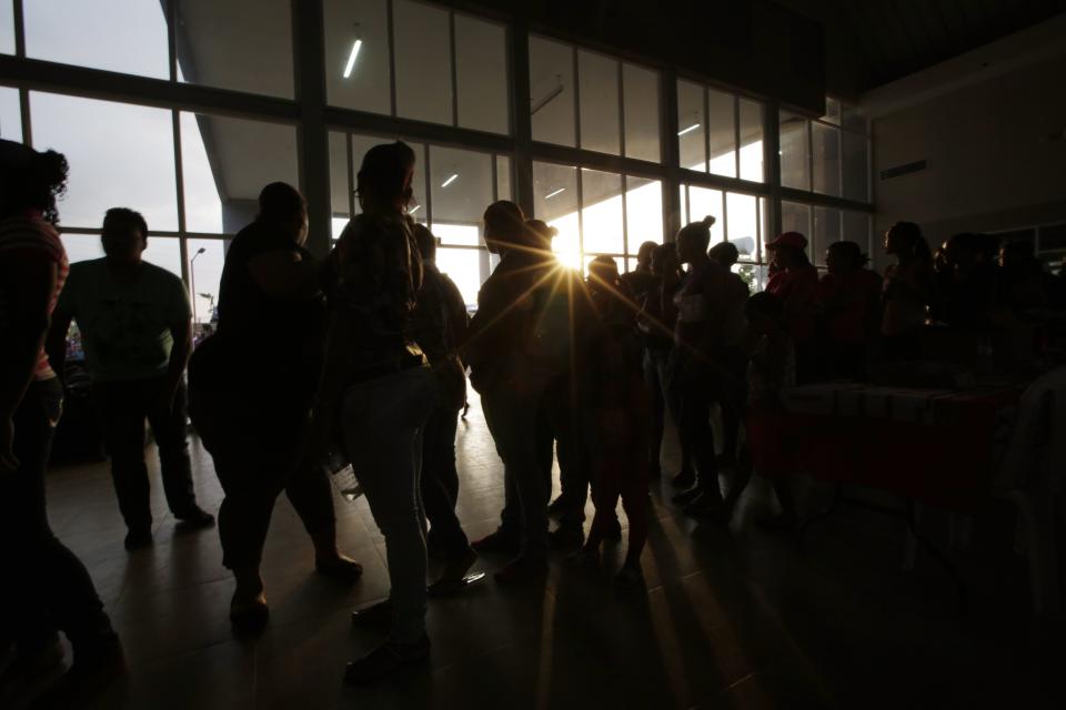 In this April 15, 2014 photo, women wait to attend a campaign event with Marta Linares, the wife of Panama's President Ricardo Martinelli, vice president candidate for the Democratic Change Party, in Panama City. From Argentina to Honduras, Latin America of late is full of examples of wives standing in for their president-husbands, but Panama would seem less fertile ground for such a tactic. Since democracy was restored after the U.S. military ousted military dictator Manuel Noriega 24 years ago, no incumbent has managed to elect their chosen successor. Panama will hold general elections on May 4. (AP Photo/Arnulfo Franco)