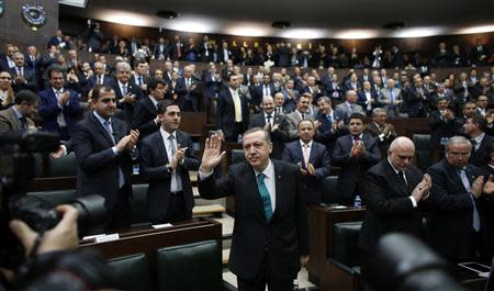 Turkey's Prime Minister Tayyip Erdogan greets his supporters as he arrives at a meeting at the Turkish parliament in Ankara February 11, 2014. REUTERS/Umit Bektas