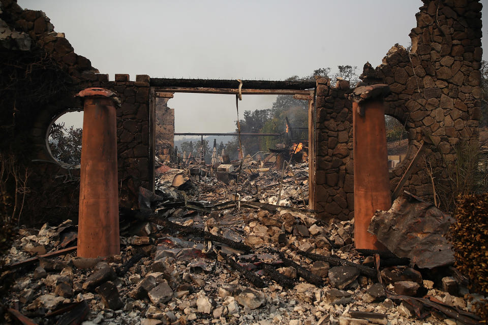 <p>The remains of the fire damaged Signarello Estate Winery after an out of control wildfire moved through the area on Oct. 9, 2017 in Napa, Calif. Tens of thousands of acres and hundreds of homes and businesses have burned in widespread wildfires that are burning in Napa and Sonoma counties. (Photo: Justin Sullivan/Getty Images) </p>