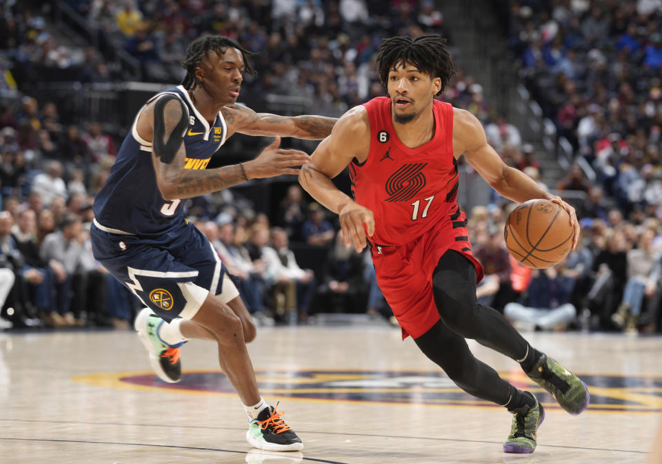 Portland Trail Blazers guard Shaedon Sharpe, right, drives past Denver Nuggets guard Bones Hyland in the first half of an NBA basketball game Tuesday, Jan. 17, 2023, in Denver. (AP Photo/David Zalubowski)