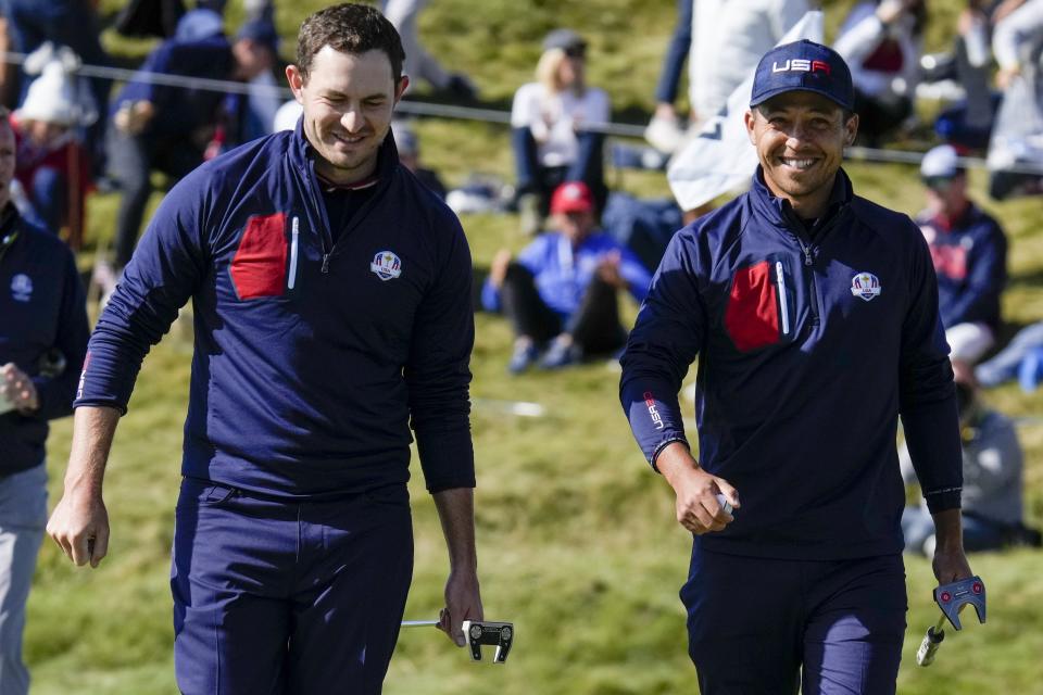 Team USA's Patrick Cantlay and Team USA's Xander Schauffele smile after winning the hole during a foursomes match the Ryder Cup at the Whistling Straits Golf Course Saturday, Sept. 25, 2021, in Sheboygan, Wis. (AP Photo/Ashley Landis)