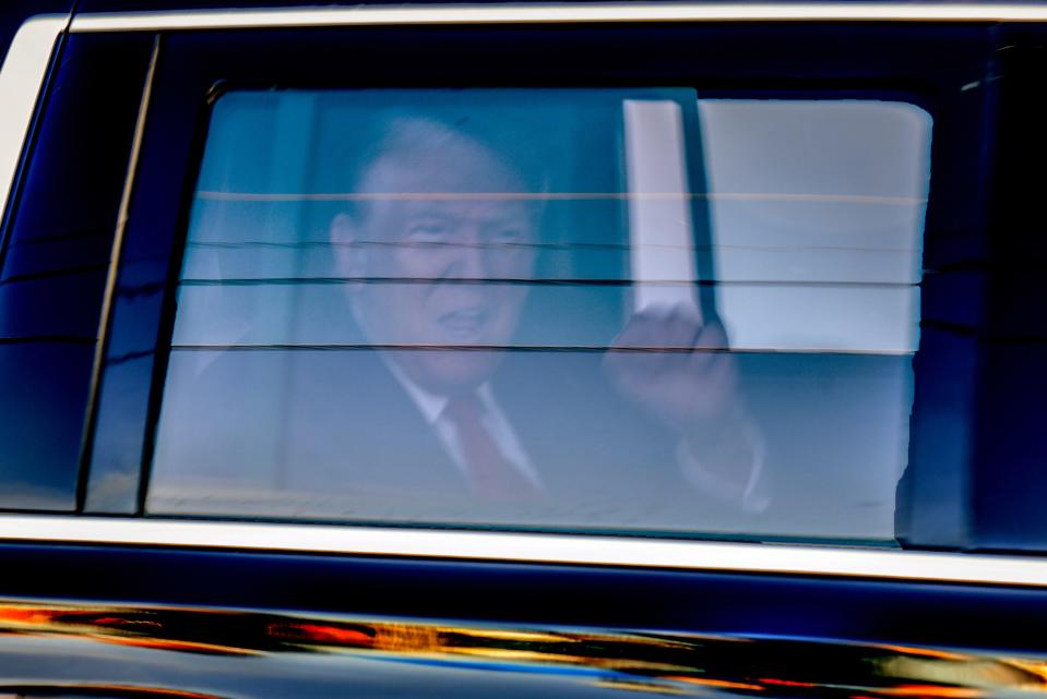 Behind the federal courthouse in Fort Pierce, Florida, former President Trump's SUV pulls in to the underground garage during past visits, people gather to greet him on March 14, 2024.