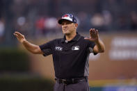FILE - Umpire Chad Fairchild calls a play review safe during the fourth inning of the second baseball game of a doubleheader between the Detroit Tigers and the Cleveland Guardians, Monday, July 4, 2022, in Detroit. A rule change at the beginning of the season designed to explain on-field call challenges and outcomes introduced umpires’ voices to ballpark speakers, to the fans in their seats and to the world at home for the first time. (AP Photo/Carlos Osorio, File)