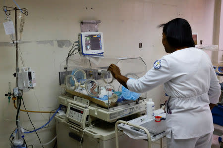 Carolina Urbina checks a premature baby in an incubator at the Concepcion Palacios Hospital in Caracas, Venezuela September 13, 2018. Picture taken September 13, 2018. REUTERS/Marco Bello