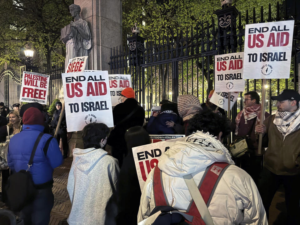 Pro-Palestinian protesters demonstrate outside the main gate at Columbia University, in New York, early Friday, April 26, 2024. (AP Photo/Aaron Morrison)