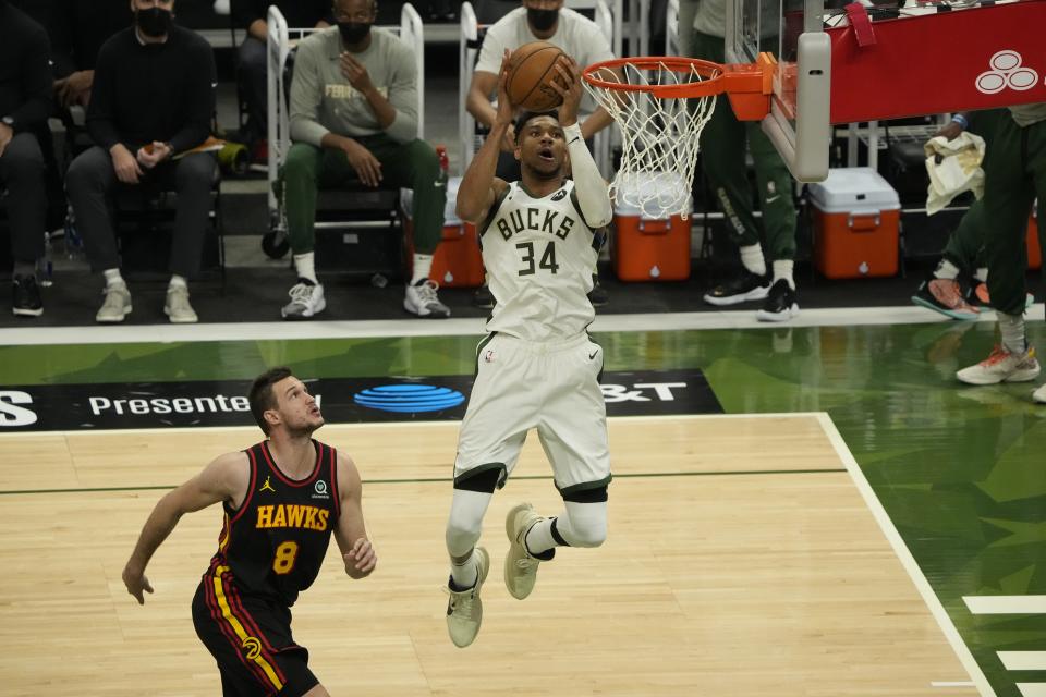 Milwaukee Bucks' Giannis Antetokounmpo shoots past Atlanta Hawks' Danilo Gallinari during the first half of Game 2 of the NBA Eastern Conference basketball finals game Friday, June 25, 2021, in Milwaukee. (AP Photo/Morry Gash)