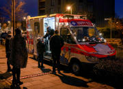 FILE - A medical worker carries out a rapid test in a test mobile in Frankfurt, Nov. 17, 2021. Numbers of the coronavirus infections in Germany reached a new record high on Wednesday. Germany is set to mark 100,000 deaths from COVID-19 this week, passing a somber milestone that several of its neighbors crossed months ago but which some in Western Europe's most populous nation had hoped to avoid. (AP Photo/Michael Probst, File)