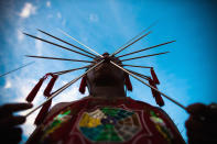 PHUKET, THAILAND - OCTOBER 04: A devotee of the Chinese shrine of Kathu Shrine, pierces his cheeks with skewers during a procession of Vegetarian Festival on October 4, 2011 in Phuket, Thailand. Ritual Vegetarianism in Phuket Island traces it roots back to the early 1800's. The festival begins on the first evening of the ninth lunar month and lasts for nine days. Participants in the festival perform acts of body piercing as a means of shifting evil spirits from individuals onto themselves and bring the community good luck. (Photo by Athit Perawongmetha/Getty Images)