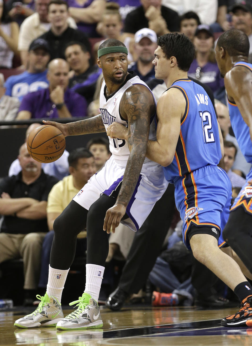 Oklahoma City Thunder center Steven Adams, right, of New Zealand, guards Sacramento Kings center DeMarcus Cousins during the first quarter of an NBA basketball game, Tuesday, April 8, 2014, in Sacramento, Calif. (AP Photo/Rich Pedroncelli)