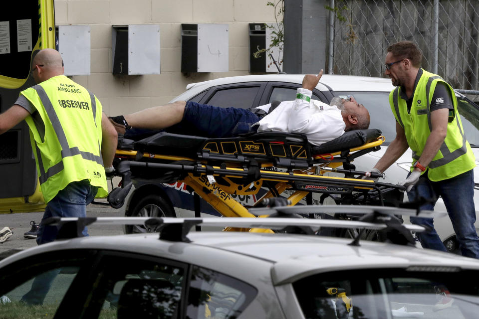 FILE - Ambulance staff take a man from outside the Al Noor mosque following a mass shooting March 15, 2019, in central Christchurch, New Zealand. Survivors from the mass shooting at two Christchurch mosques describe their reactions to the Buffalo supermarket shooting. The Buffalo gunman was apparently inspired by the Christchurch shooter after watching a copy of his livestream video. (AP Photo/Mark Baker, File)