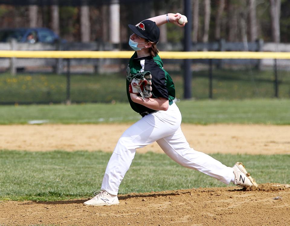 Sophomore Jack Keane pitches to a batter during baseball practice at Marshfield High on Wednesday, April 28, 2021. 