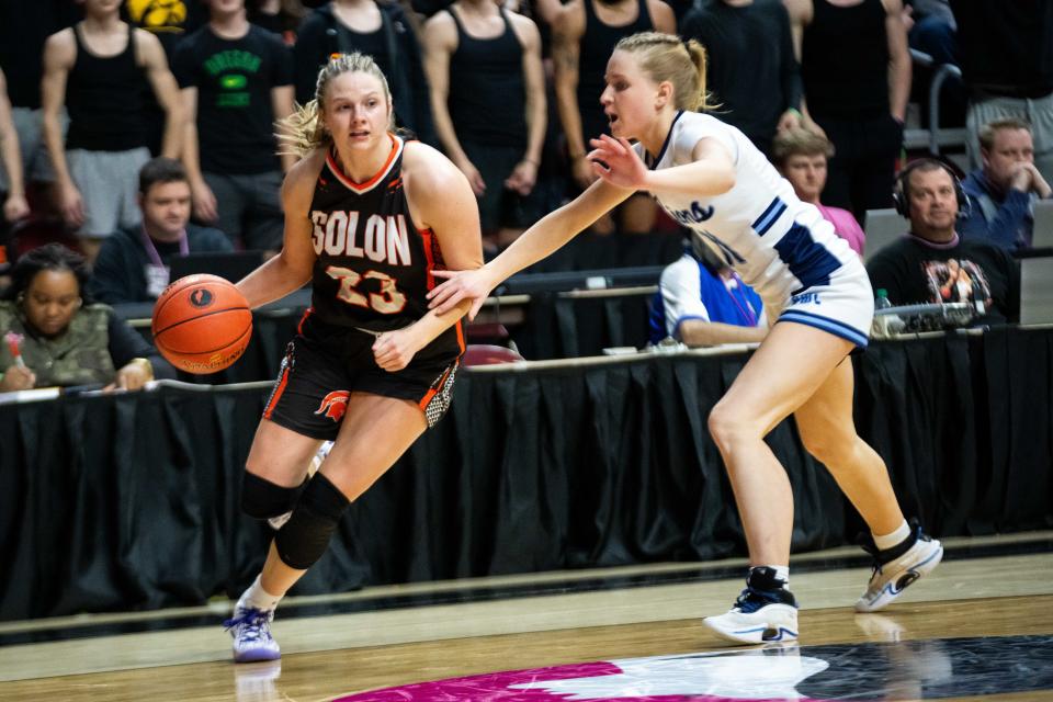 Solon's Callie Levin (10) drives past Des Moines Christian's Meg Muller in the 3A state semifinals on Thursday, Feb. 29, 2024, at Wells Fargo Arena.