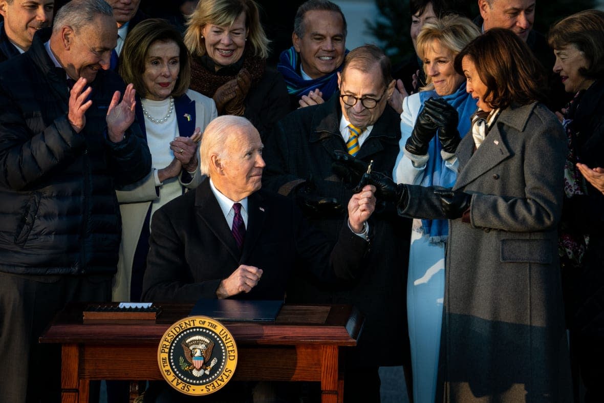 WASHINGTON, DC – DECEMBER 13: President Joe Biden gives Vice President Kamala Harris the pen he used to sign H.R. 8404, The Respect for Marriage Act, into law during a ceremony on the South Lawn of the White House on Tuesday, Dec. 13, 2022 in Washington, DC. (Kent Nishimura / Los Angeles Times via Getty Images)