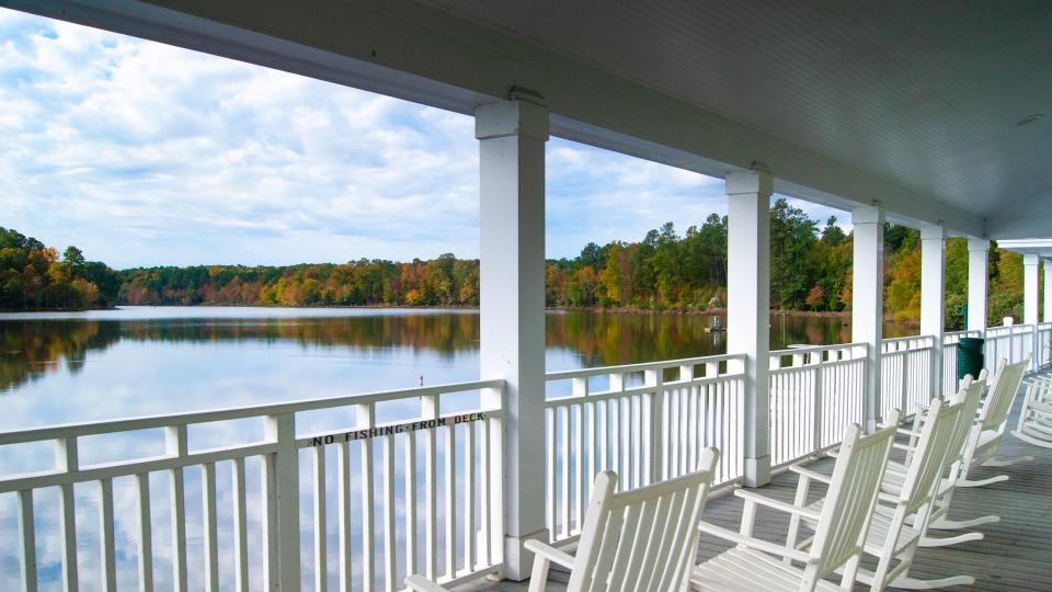 Rocking chairs on the balcony on a lake at sunset in Holly Springs, North Carolina.