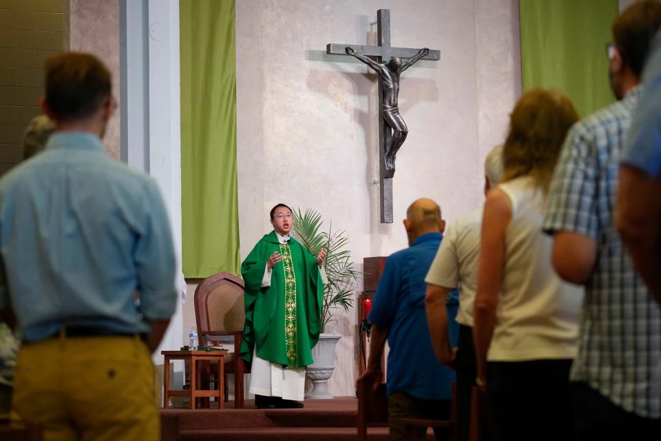 Jul 3, 2022; Columbus, Ohio, USA;  Fr. Jimmy Hsu, CSP leads Catholic mass at the Newman Center, the parish and student ministry at Ohio State on July 3, 2022. The diocese is being taken from the Paulist fathers, an order of Catholic priests, who have run it for 65 years.  Mandatory Credit: Adam Cairns-The Columbus Dispatch