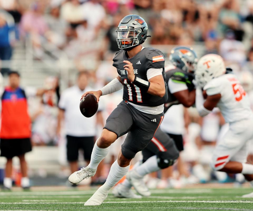 Skyridge’s Jackson Stevens scrambles with the ball as he looks for a receiver against Timpview.