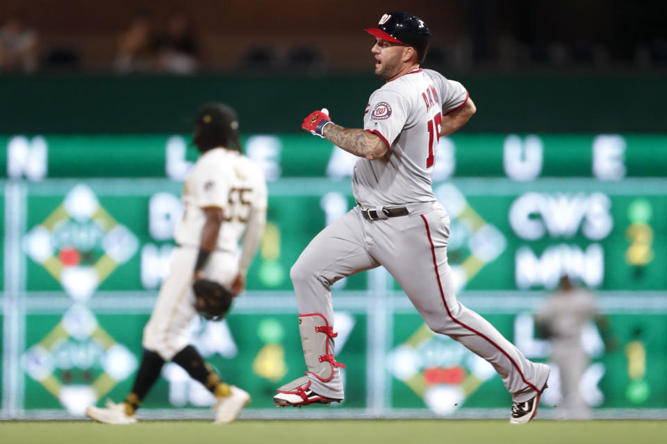 Washington Nationals' Matt Adams runs into second base behind Pittsburgh Pirates first baseman Josh Bell with double driving in Asdrubal Cabrera in the fourth inning of a baseball game, Monday, Aug. 19, 2019, in Pittsburgh. (AP Photo/Keith Srakocic)