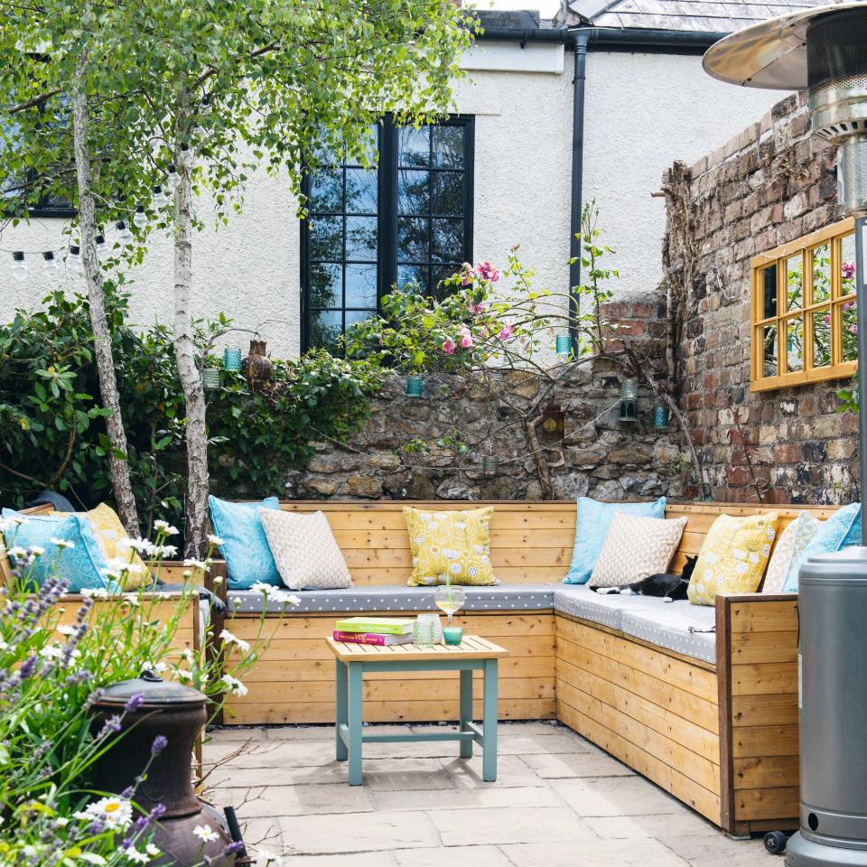 wooden garden seating covered in cushions