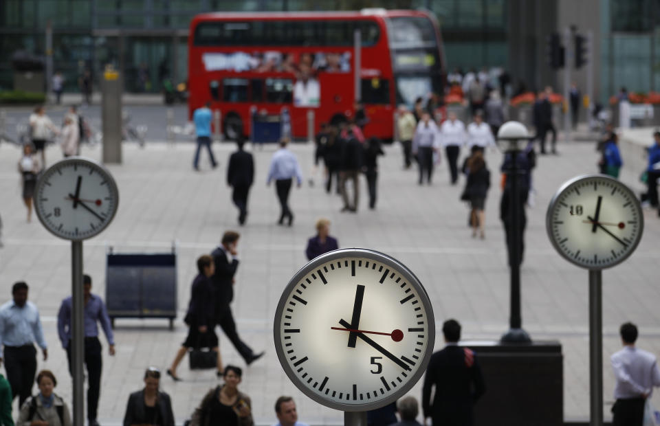 Pedestrians walk through the Canary Wharf  business district in London September 12, 2011. Britain's banks face some of the world's toughest regulations under reforms outlined on Monday, which require them to insulate their retail lending activities and store up billions in extra capital at an annual cost of up to 7 billion pounds ($11 billion).     REUTERS/Suzanne Plunkett (BRITAIN - Tags: BUSINESS POLITICS)