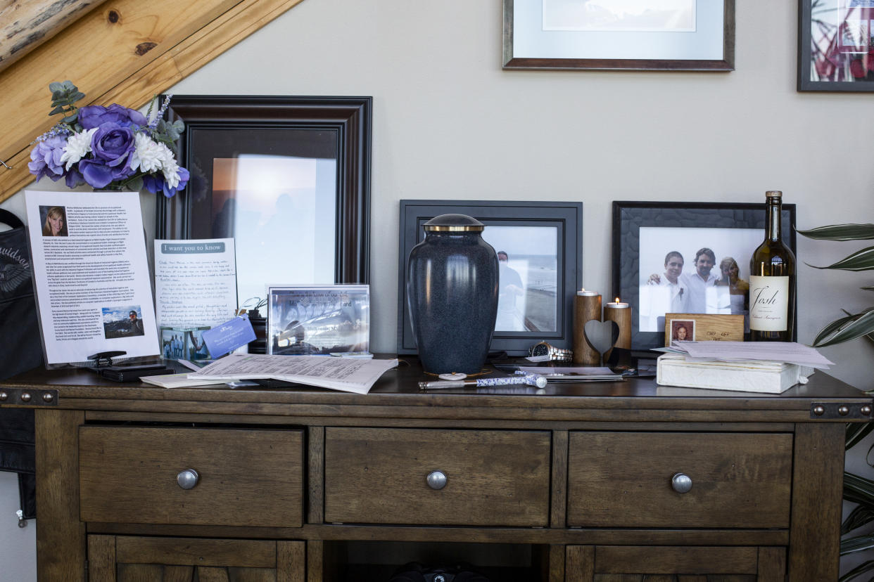 Stan Thomas placed photos and keepsakes around the urn containing the ashes of his wife, Monica Melkonian, in his home outside Bend, Ore. (Tess Freeman for KHN)