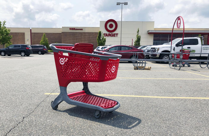 FILE - In this June 3, 2019, file photo a shopping cart sits in the parking lot of a Target store in Marlborough, Mass. Plenty of retailers like Target and Walmart allow shoppers to drop off online returns at their stores. But now, a growing number of retailers are accepting rivals’ returns. (AP Photo/Bill Sikes, File)