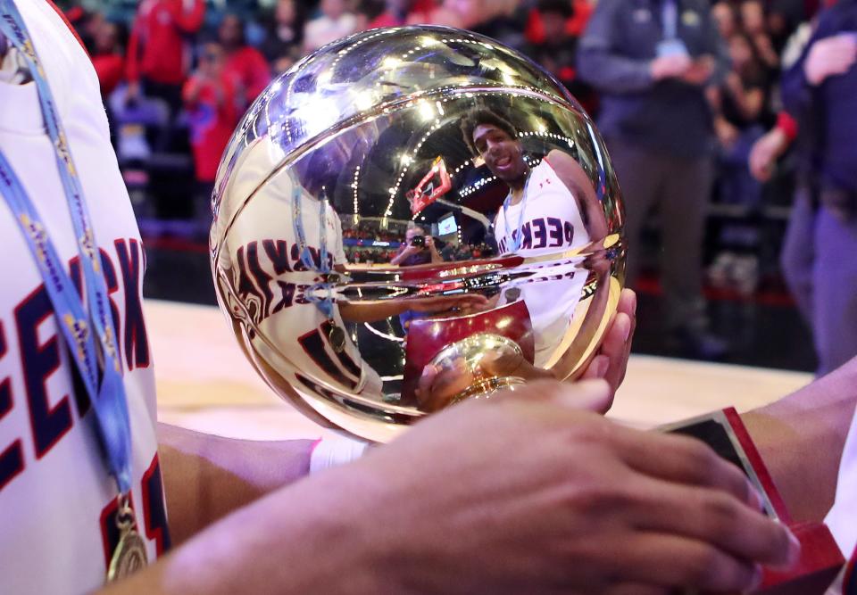 PeekskillÕs Travis Brown and Amir Thomas celebrate with the gold ball as they celebrate their victory over Suffern in the Section 1 boys Class AA championship at the Westchester County Center in White Plains March 2, 2024.