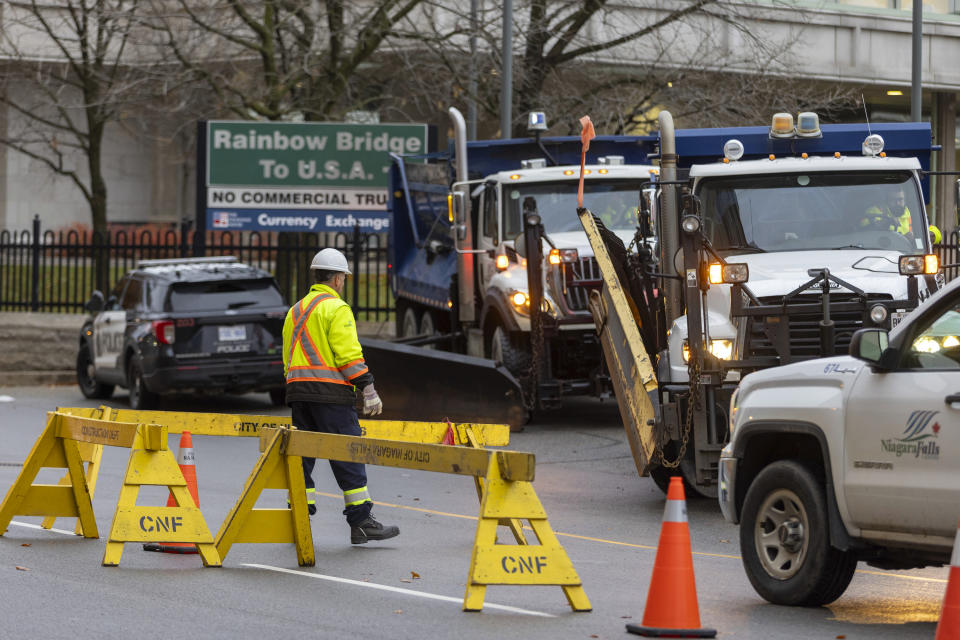 Trucks are positioned to block the entrance to the Rainbow Bridge border crossing between the U.S. and Canada, Wednesday, Nov. 22, 2023, in Niagara Falls, Ontario, after a vehicle exploded at a checkpoint on the American side of the bridge (Carlos Osorio/The Canadian Press via AP)
