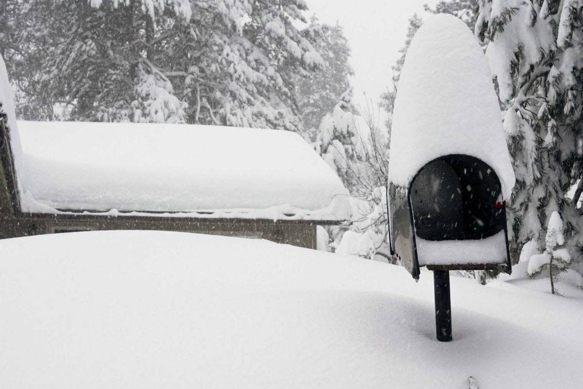 A mailbox and the roof of a home are covered in snow during a storm, Saturday, March 2, 2024, in Truckee, Calif. A powerful blizzard howled Saturday in the Sierra Nevada as the biggest storm of the season shut down a long stretch of Interstate 80 in California and gusty winds and heavy rain hit lower elevations, leaving tens of thousands of homes without power. Brooke Hess-Homeier/AP