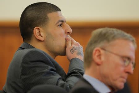 Former New England Patriots football player Aaron Hernandez (L) and his attorney Charles Rankin listen as prosecution witness Alexander Bradley is questioned by the prosecution without the jury present at Bristol County Superior Court in Fall River, Massachusetts April 1, 2015. REUTERS/Brian Snyder