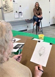 Judy Mengel of Millersburg sketches a model during portrait drawing class at Holmes Center for the Arts.