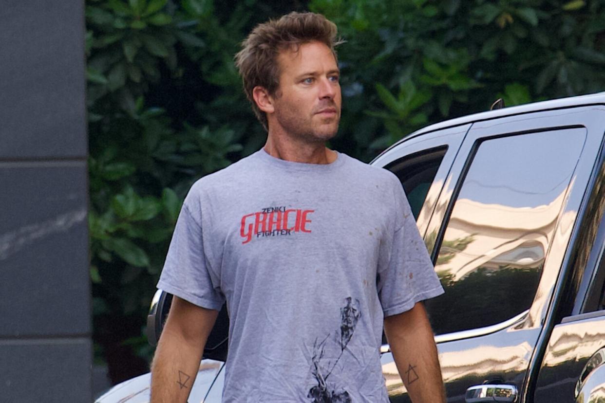 EXCLUSIVE: Armie Hammer wears a ripped and stained t-shirt as he emerges following lawsuit from American Express over $67K in unpaid charges.