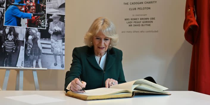 queen camilla signs book