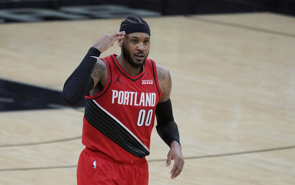 Portland Trail Blazers forward Carmelo Anthony (00) reacts after scoring against the San Antonio Spurs during the second half of an NBA basketball game in San Antonio, Friday, April 16, 2021. (AP Photo/Eric Gay)