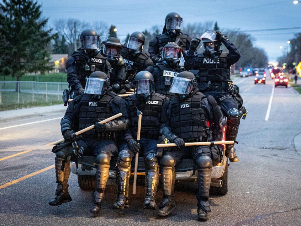 Minneapolis police officers in riot gear leave as protesters gather after an officer shot and killed a black man in Brooklyn Center, Minneapolis, Minnesota on April 11, 2021.